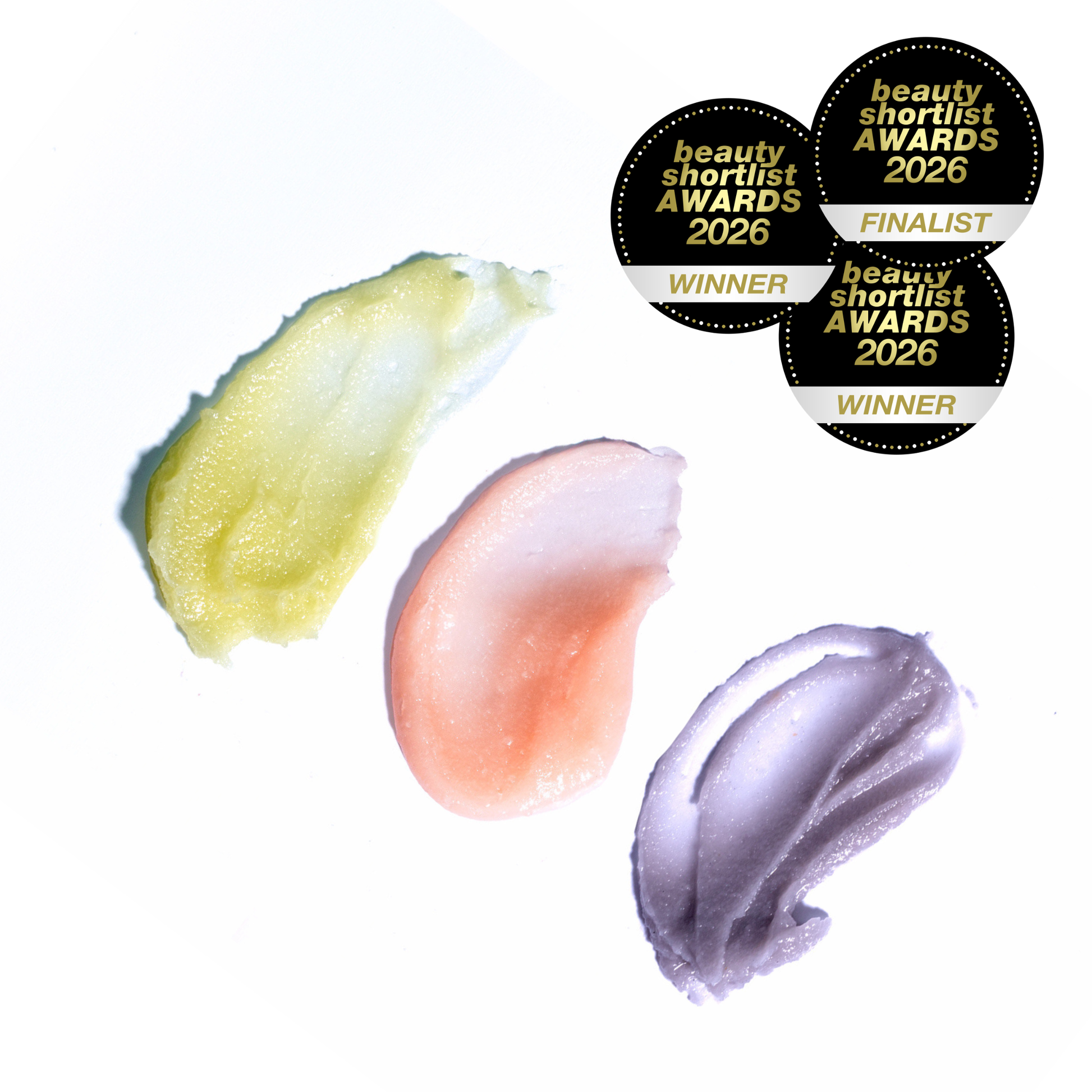 Swatches of three MATER Beauty ONE & DONE Dual-Action Cleansing Balms - Green Goddess (yellow green), Rose Above (warm gentle pink) and Force of Nature (dusky purple) on a white background