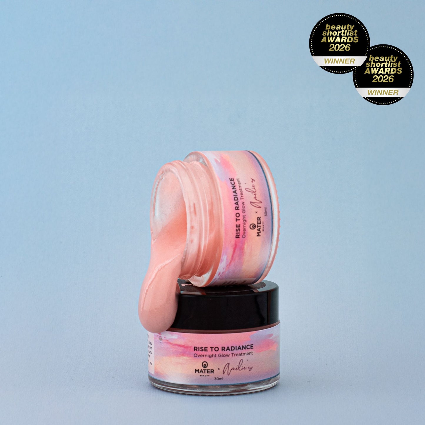 Jars of MATER Beauty Rise to Radiance Overnight Glow Treatment with pink jelly on a light blue background, featuring MATER and Amelie's branding and Beauty Shortlist Awards 2026 winner badges.