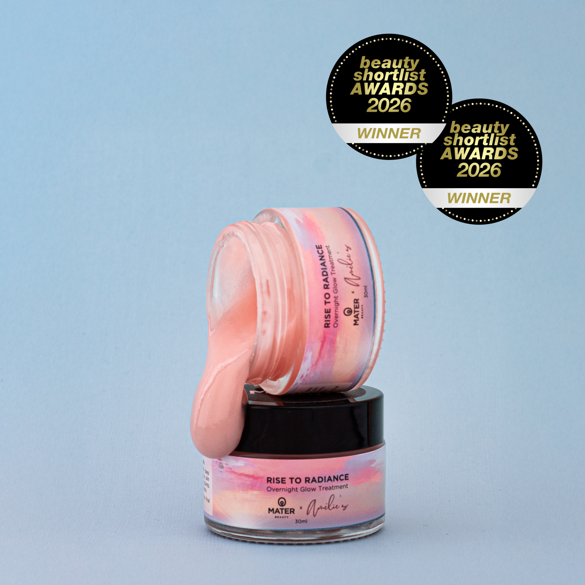 Jars of MATER Beauty Rise to Radiance Overnight Glow Treatment with pink jelly on a light blue background, featuring MATER and Amelie's branding and Beauty Shortlist Awards 2026 winner badges.